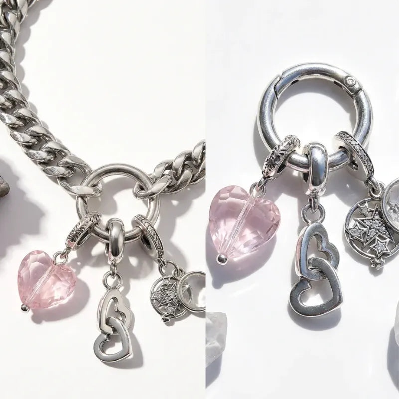 Silver charm bracelet with heart-shaped charms on a white background