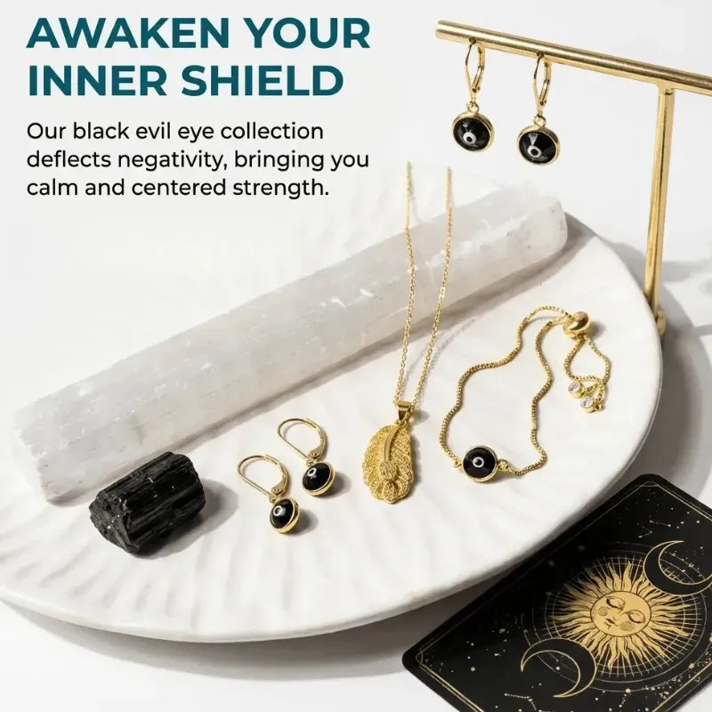 Jewelry set with black stones and gold necklaces on a white plate, with text about deflecting negativity.
