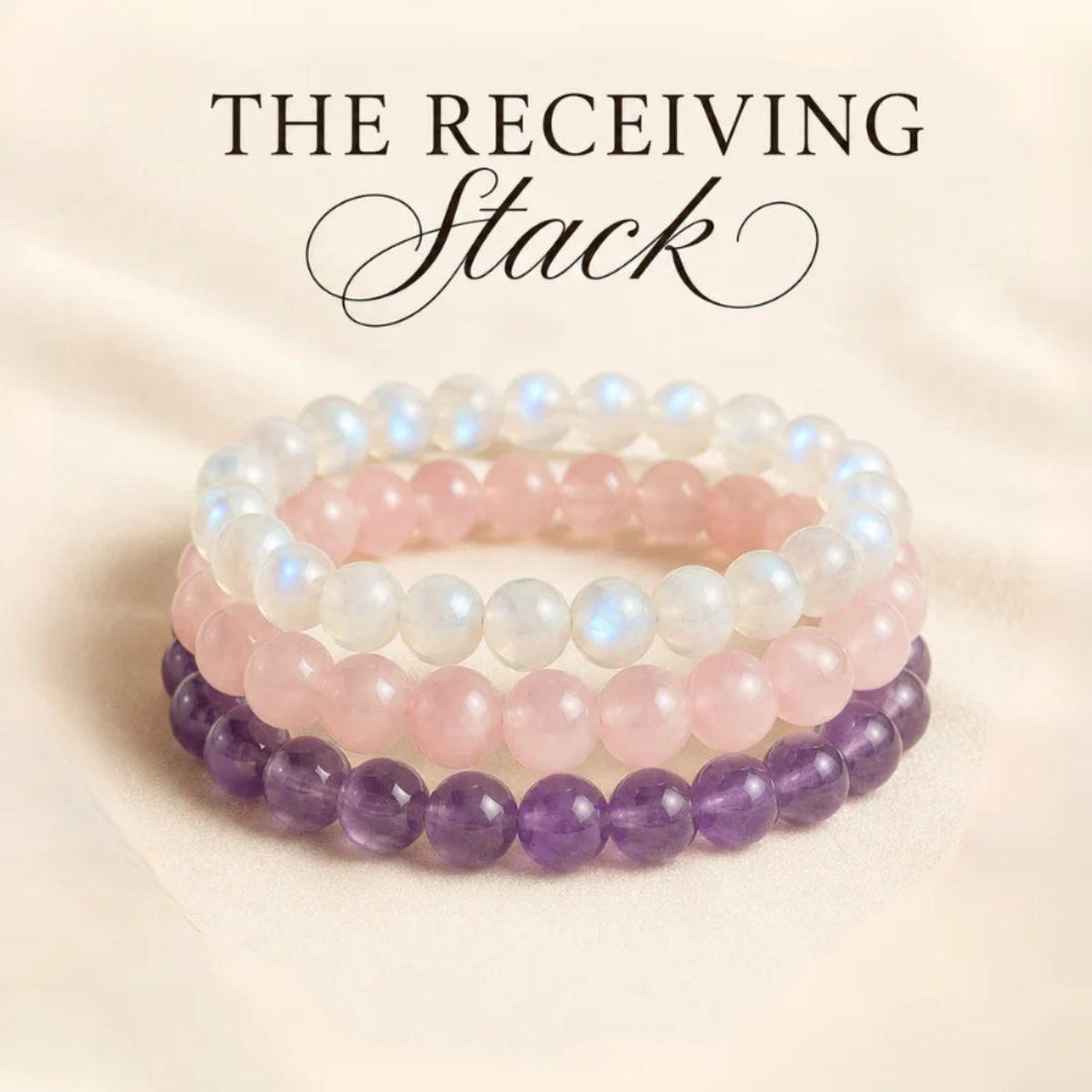 Three beaded stretch bracelets stacked together on a soft cream fabric background, with the text THE RECEIVING Stack