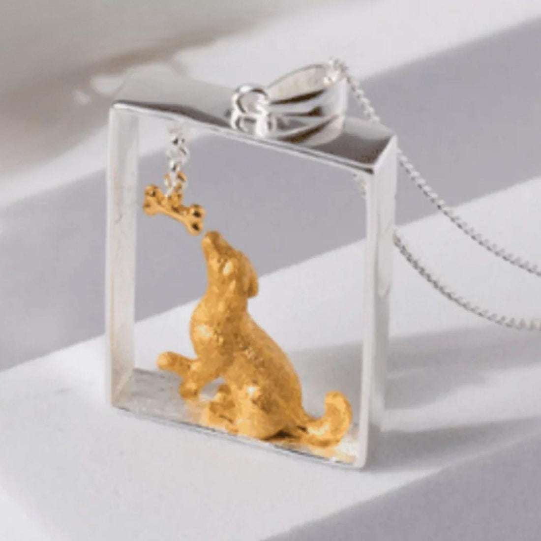 Gold paw print urn and dog bone pendant necklaces — keepsake jewelry for remembrance