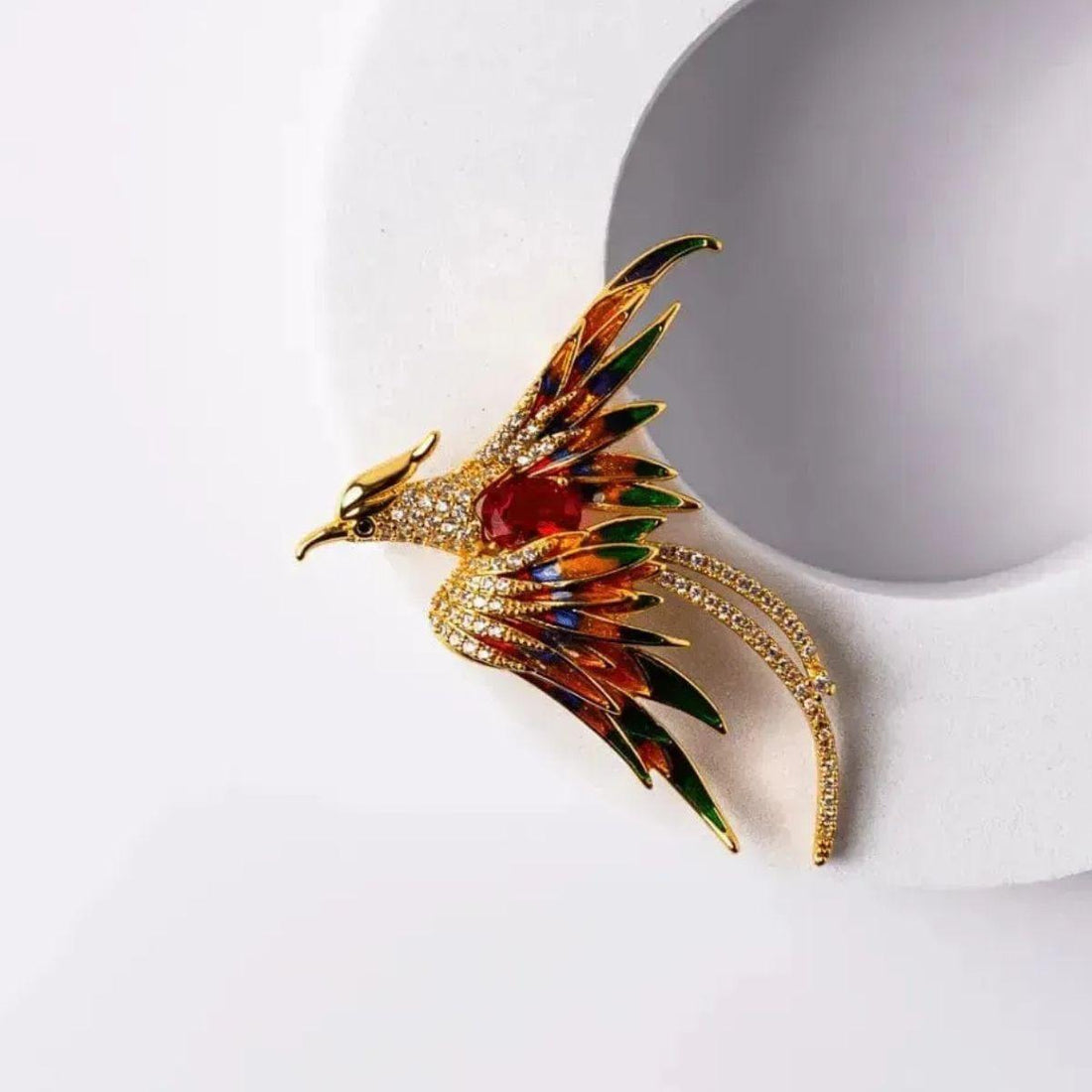 Red and orange phoenix pin in gold-plated finish, symbol of transformation and strength