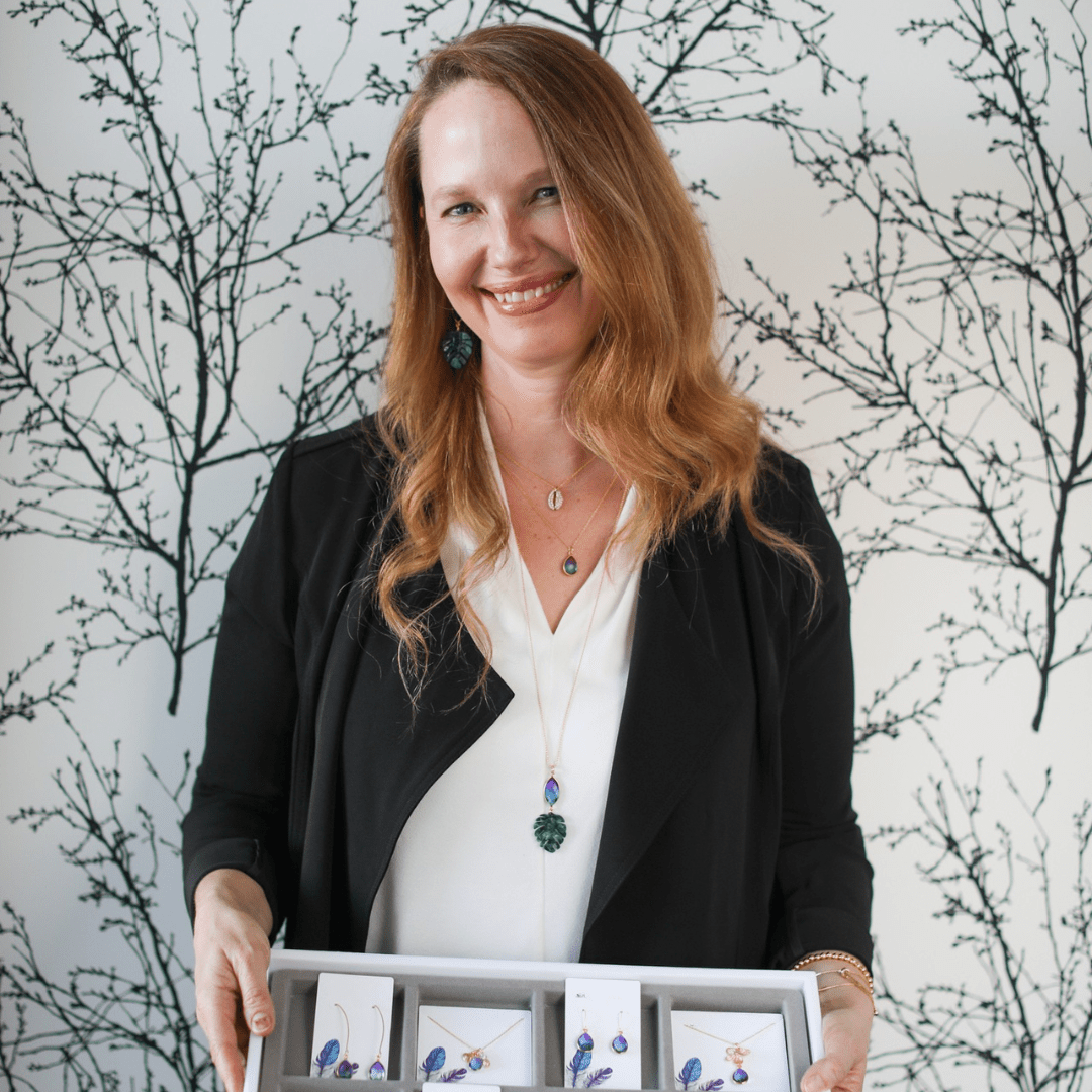 Woman holding a box of jewelry with a decorative background