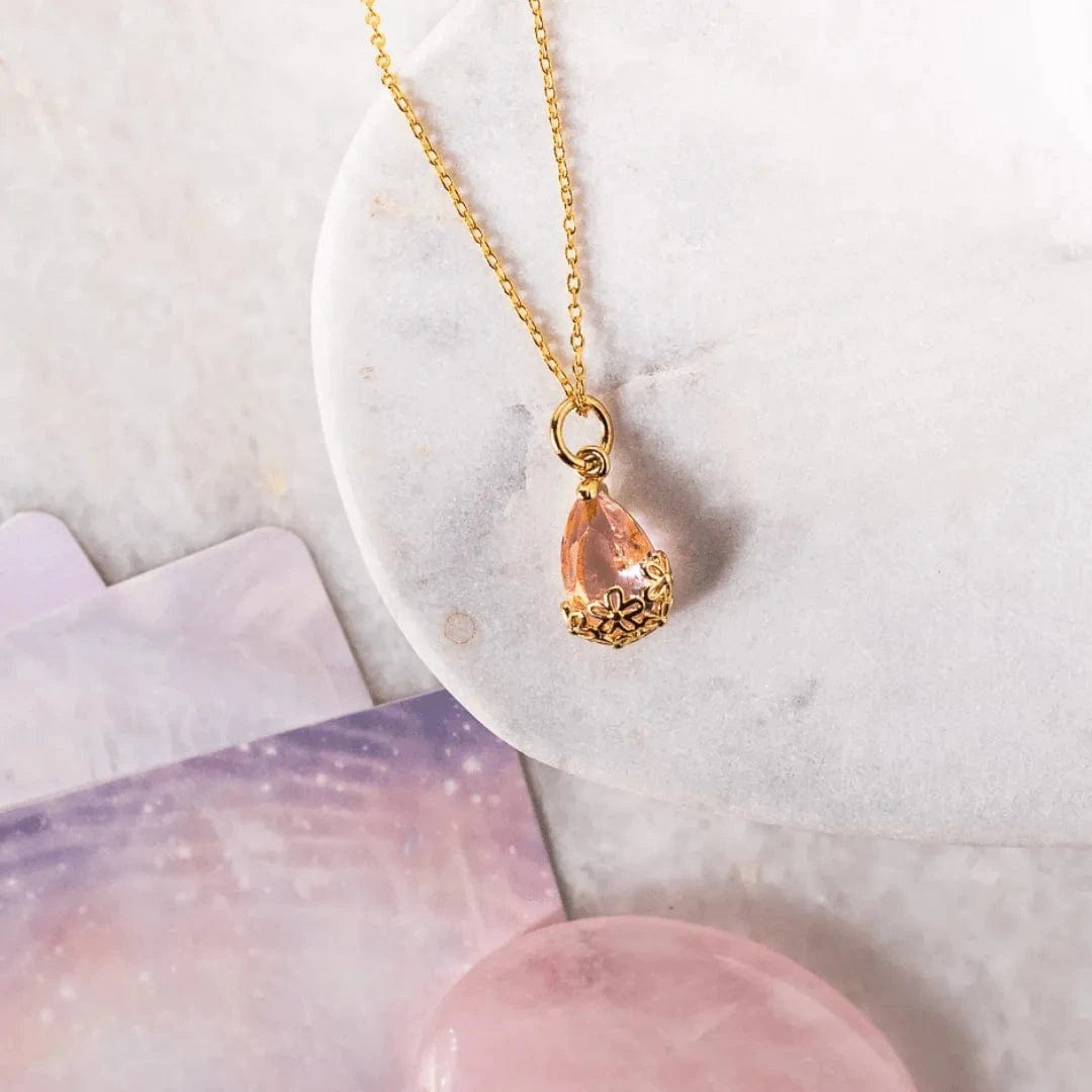 Necklace with a teardrop-shaped pendant on a marble surface