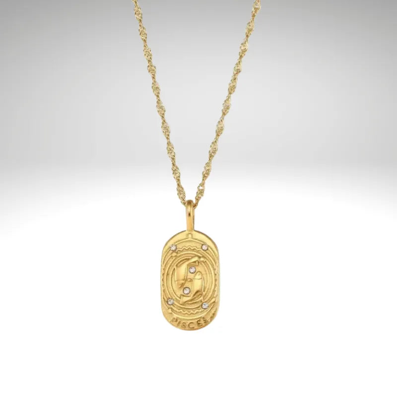 Gold necklace with a pendant on a light gray background