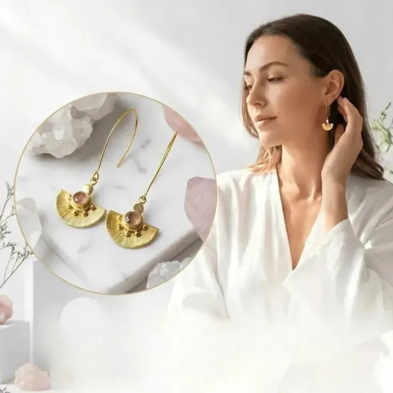 Woman wearing gold earrings with a close-up inset on a light background