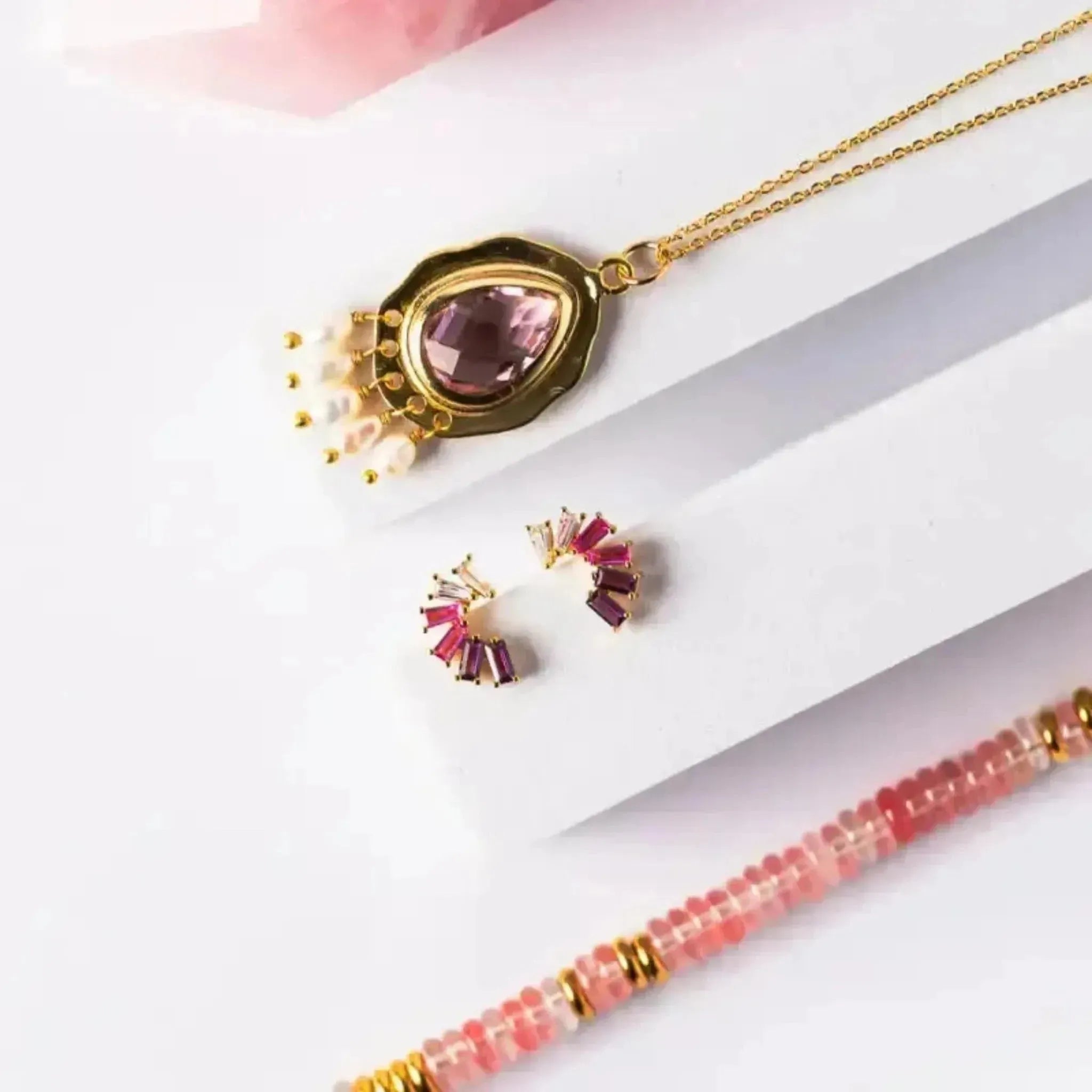 Jewelry set with a necklace, earrings, and bracelet on a white background