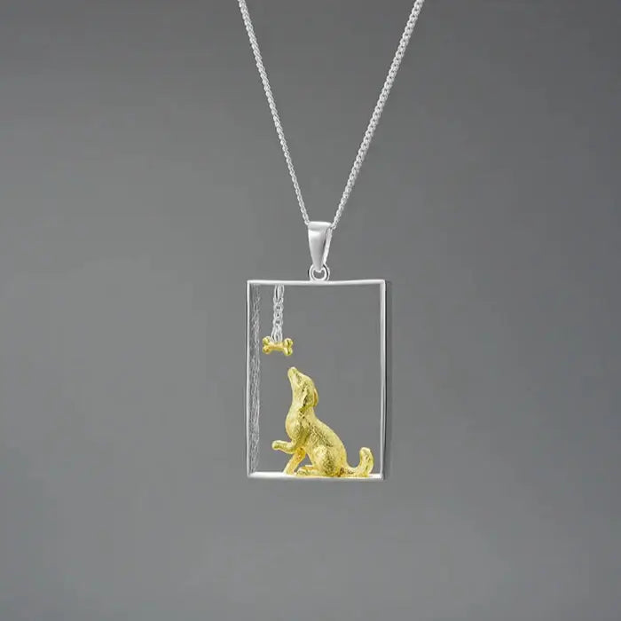 Sterling silver and gold dog portrait pendant on a chain, showcasing luxury pet jewelry design.