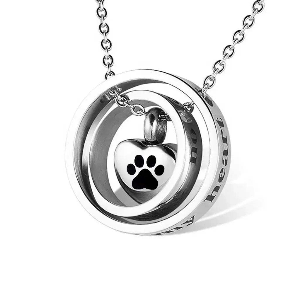 Heart urn necklace with paw print charm, memorial keepsake from Mystic Soul Jewelry.