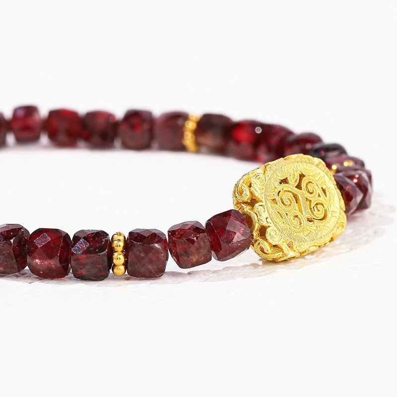 Garnet bead bracelet shown stacked with other crystal bracelets — January birthstone jewelry
