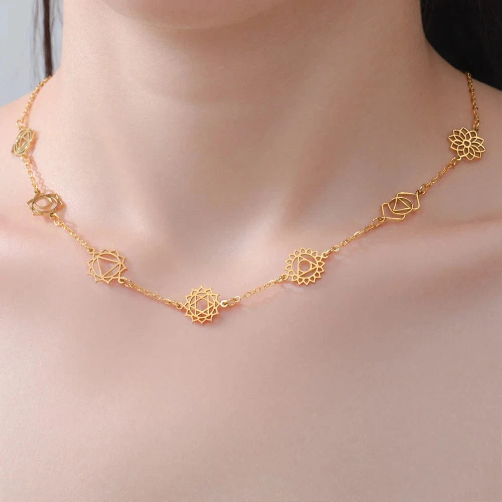 Gold necklace with floral designs on a soft background
