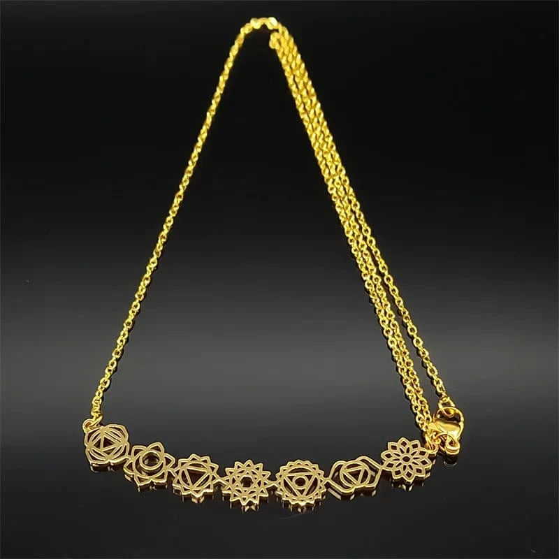 Gold necklace with floral designs on a black background