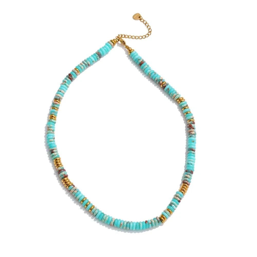 Turquoise beaded necklace with gold accents on a white background