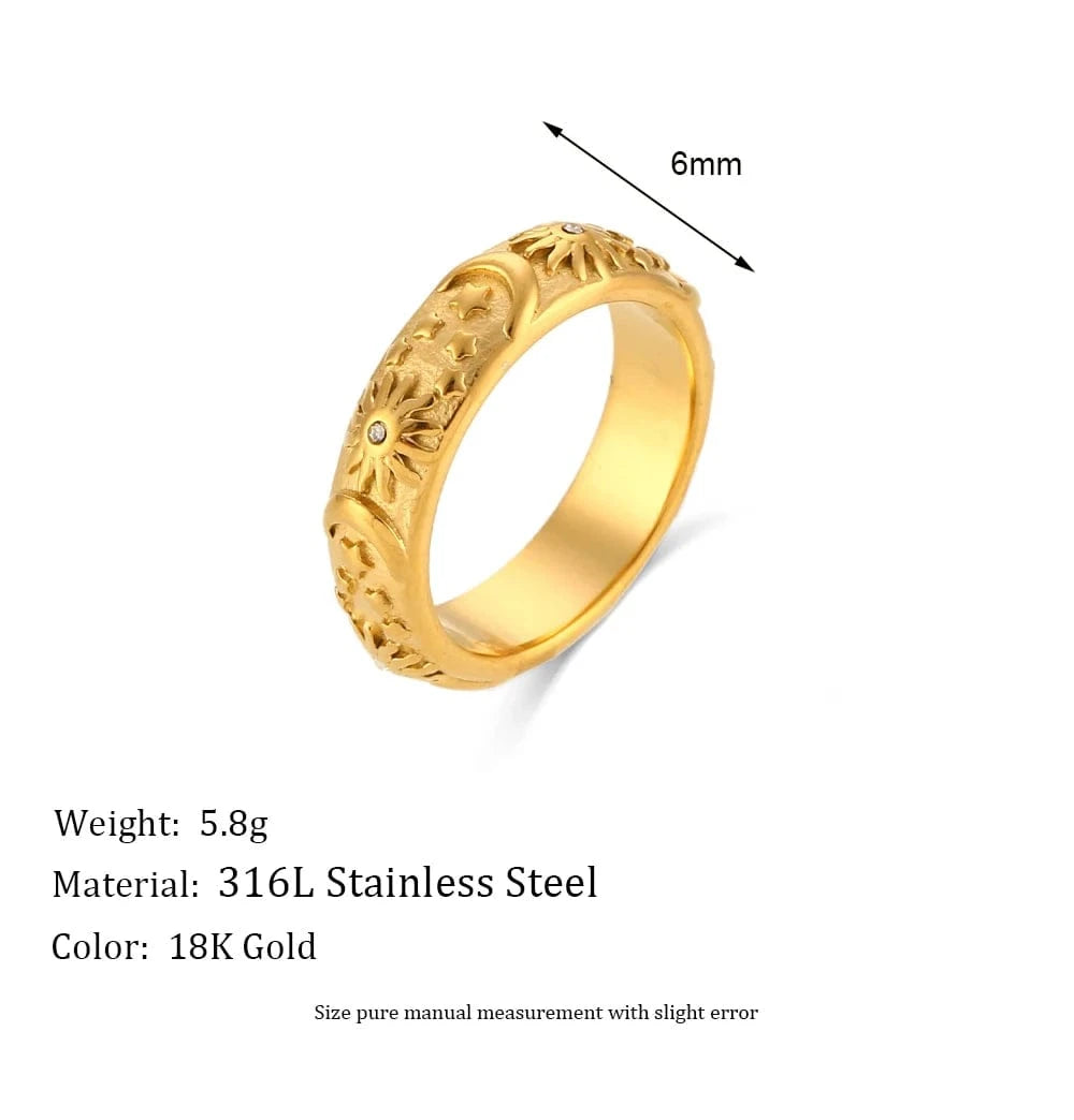 Gold ring with engraved design on a white background