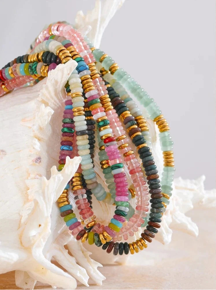 Colorful beaded bracelets on a white shell with a light background