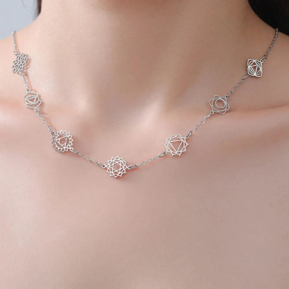 Silver necklace with geometric designs on a mannequin neck
