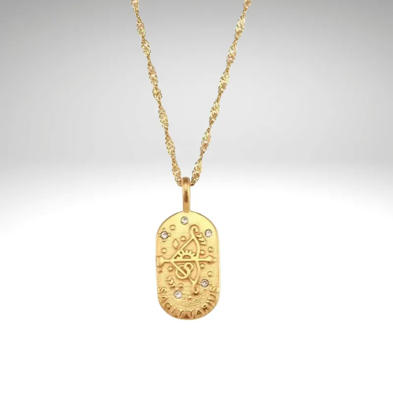 Gold necklace with a pendant on a light gray background