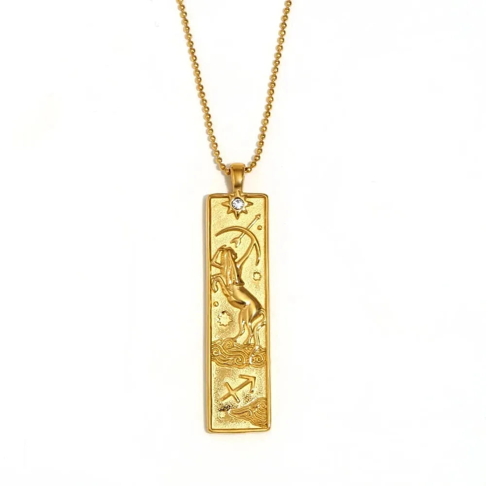 Gold pendant with zodiac design on a white background