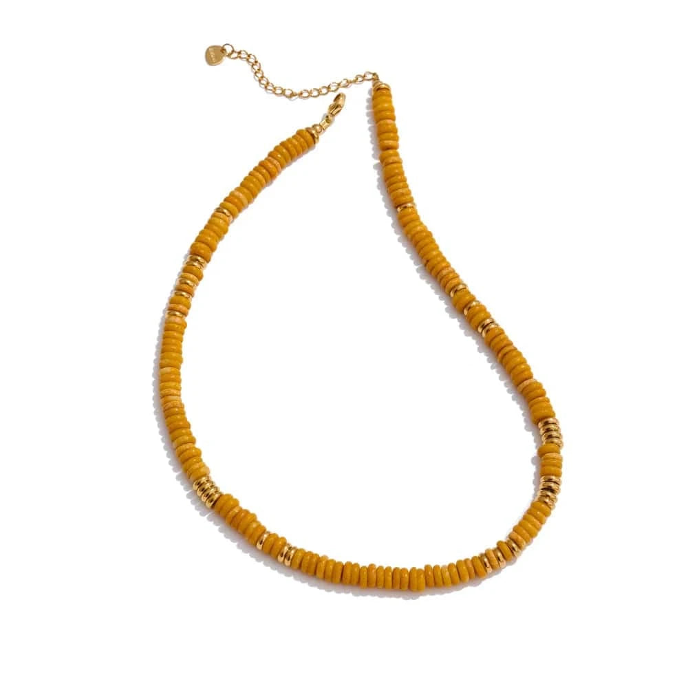 Yellow beaded necklace on a white background