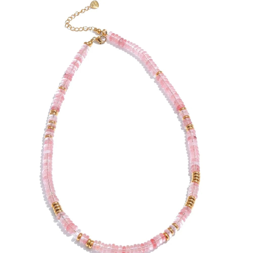 Necklace with pink beads and gold accents on a white background