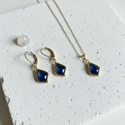 Gold Selene necklace and matching drop earrings with sapphire blue faceted glass, September birthstone colour