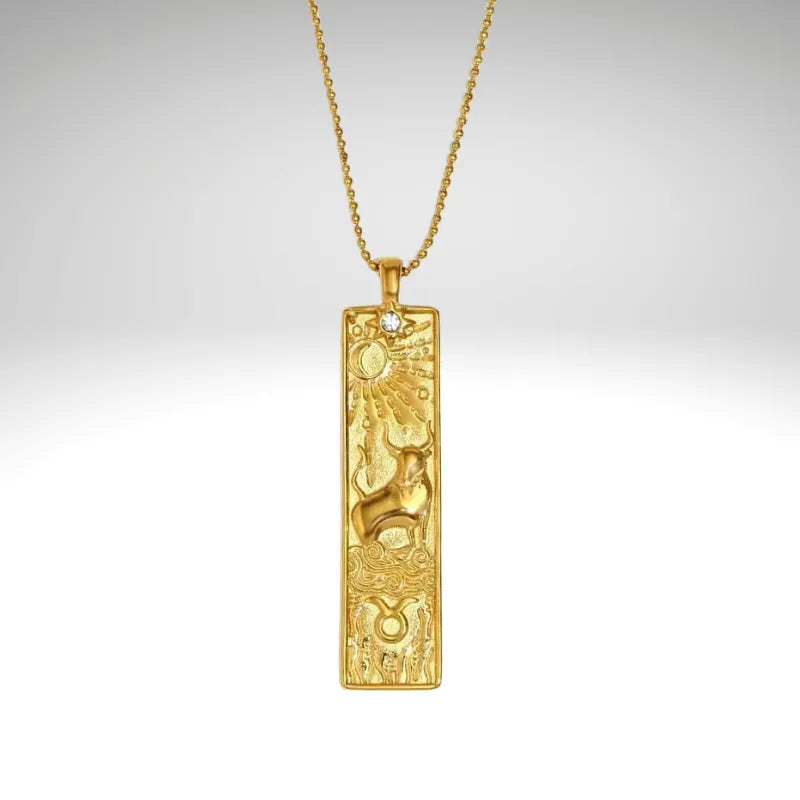Gold pendant necklace on a gray background