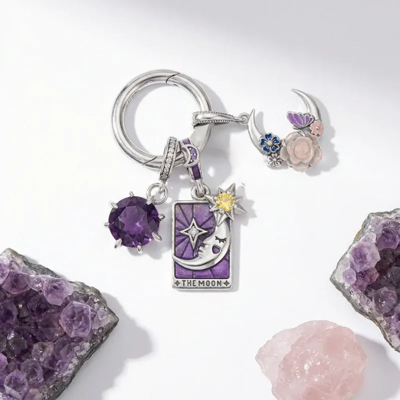 Keychain with charms including a purple gemstone, star, and moon 