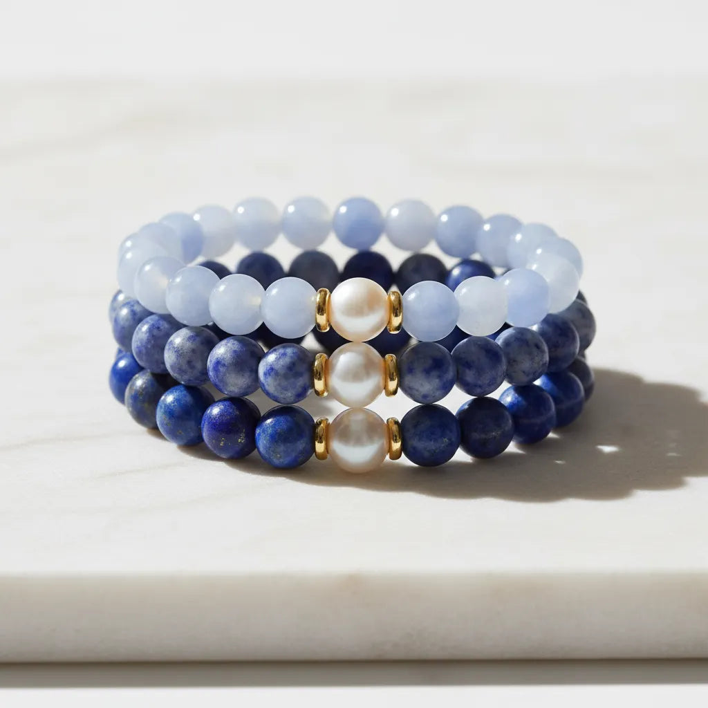 Stack of three freshwater pearl bracelets in blue lace agate, light sodalite and dark sodalite