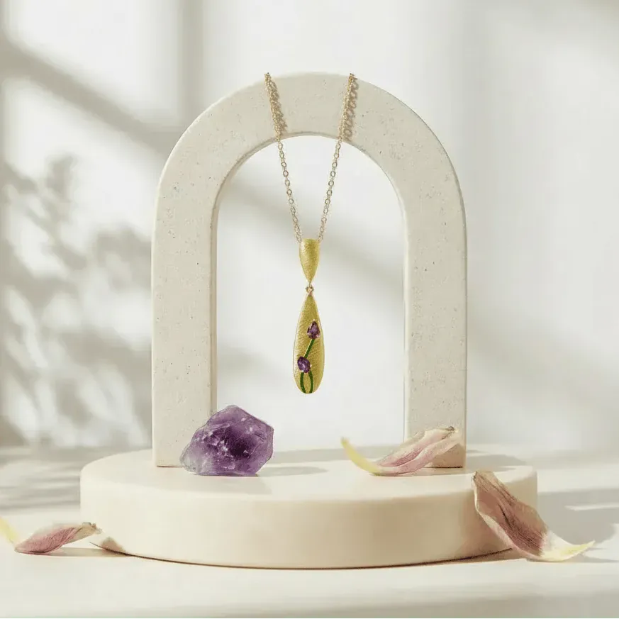 Necklace with a pendant on a decorative stand with amethyst crystal and dried flowers.