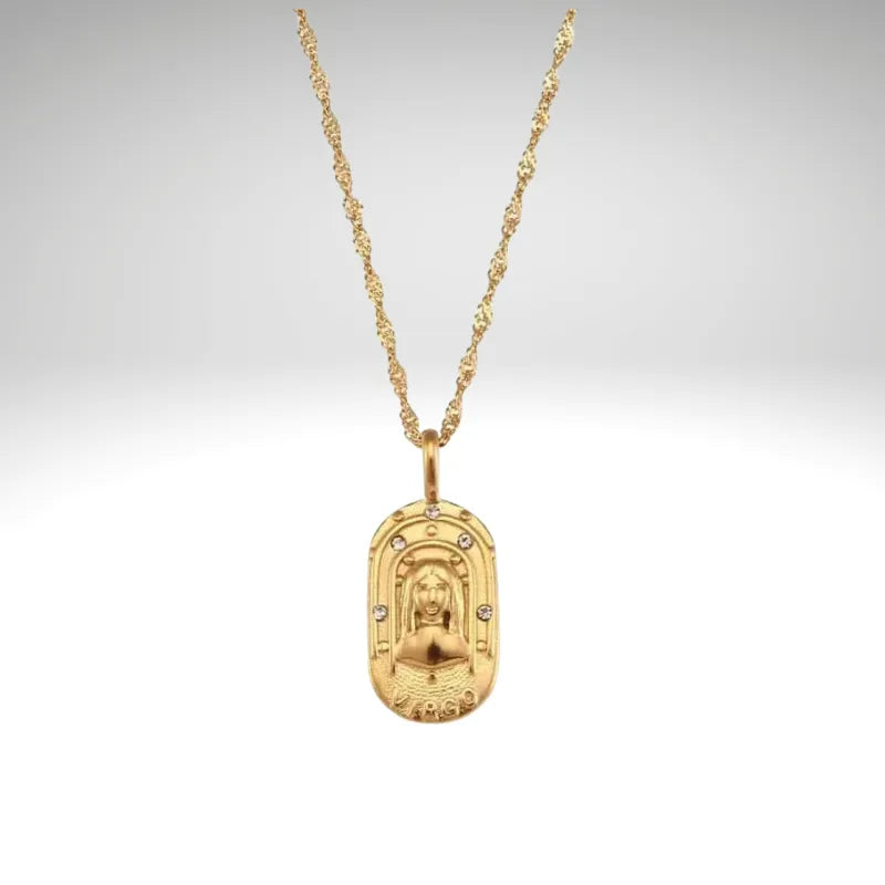 Gold necklace with a pendant on a light gray background
