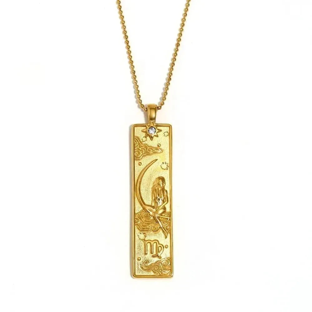 Gold pendant necklace with intricate design on a white background