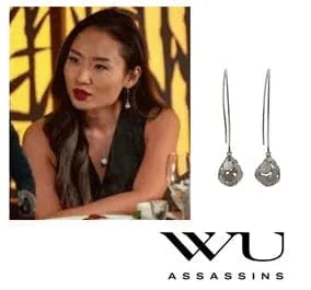 Woman wearing earrings with 'WU Assassins' branding