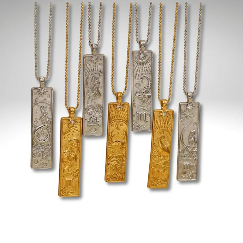 Set of gold and silver necklaces with engraved pendants on a white background