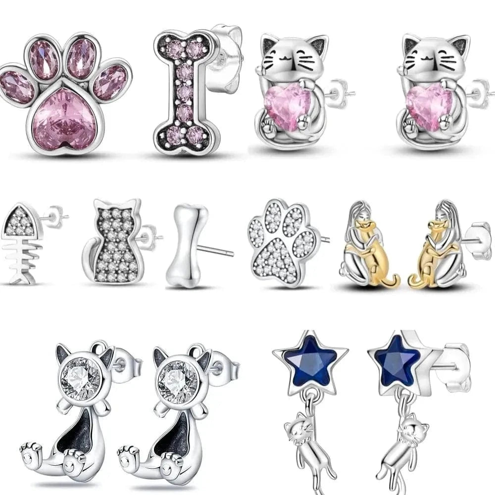 Collection of cat-themed earrings with various designs on a white background