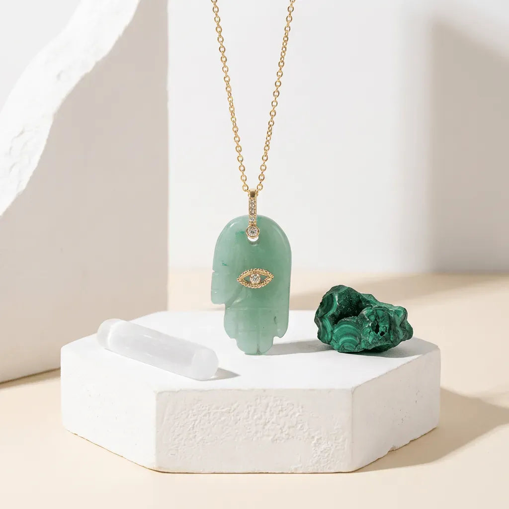 Green pendant necklace on a white stand with a neutral background