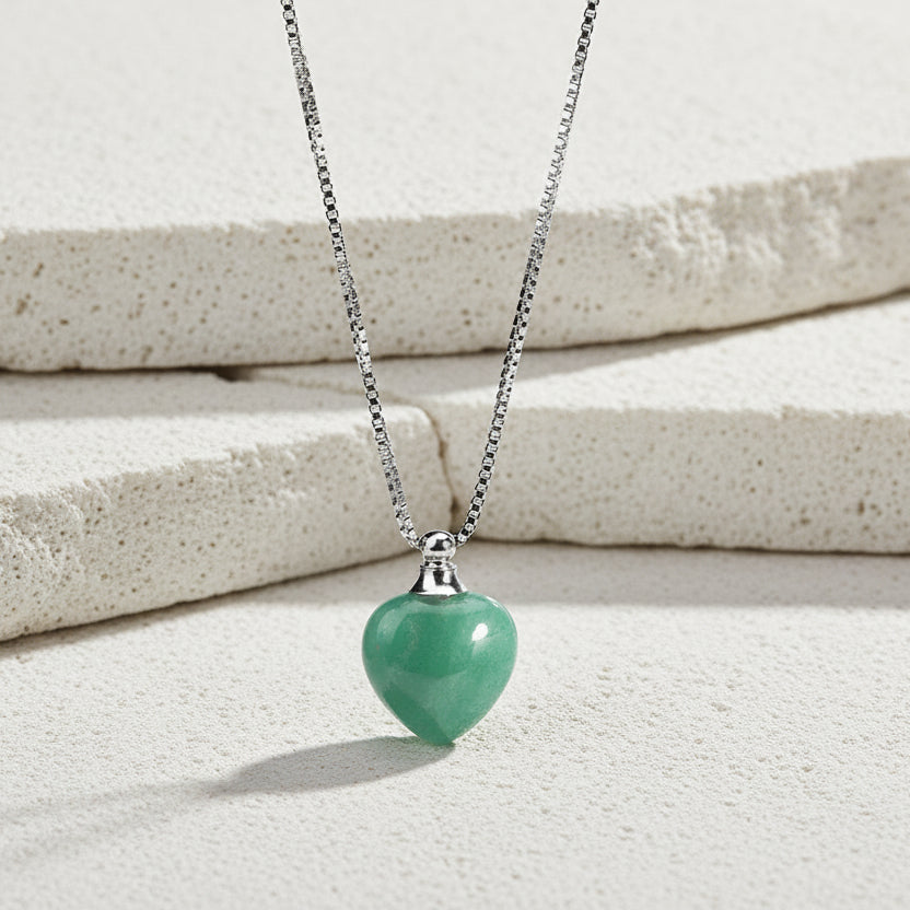 Necklace with a green heart-shaped pendant on a white background