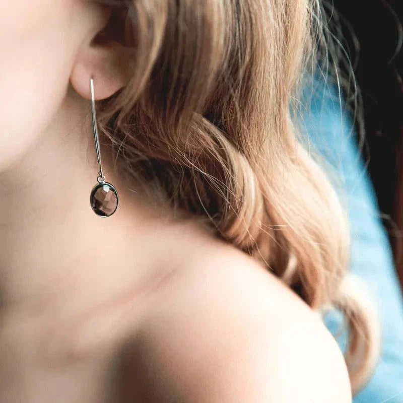 Close-up of a dangling earring with a blurred background
