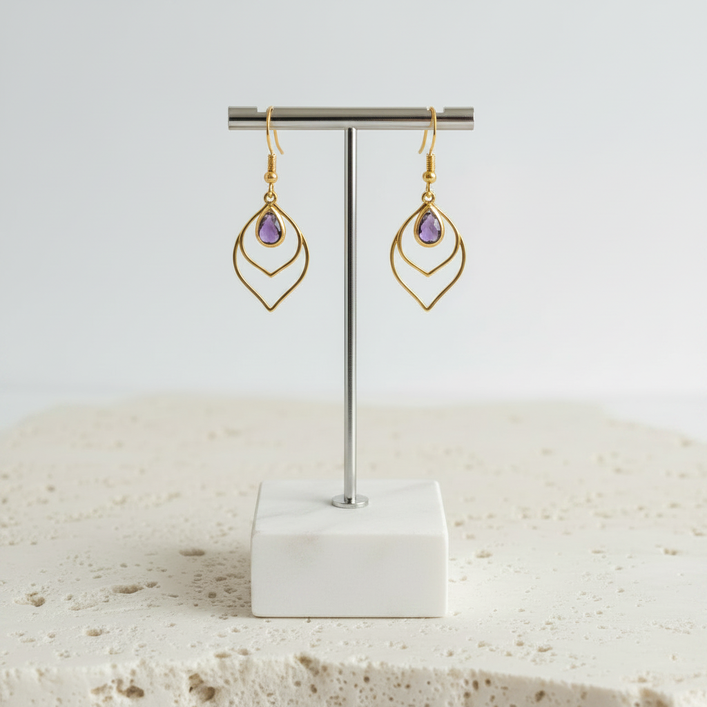 Amethyst purple faceted glass teardrop earrings in gold, shown hanging