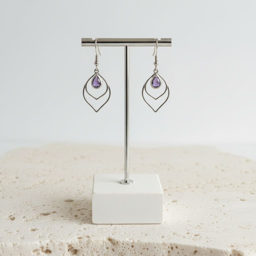 Amethyst purple faceted glass teardrop earrings in silver, shown hanging