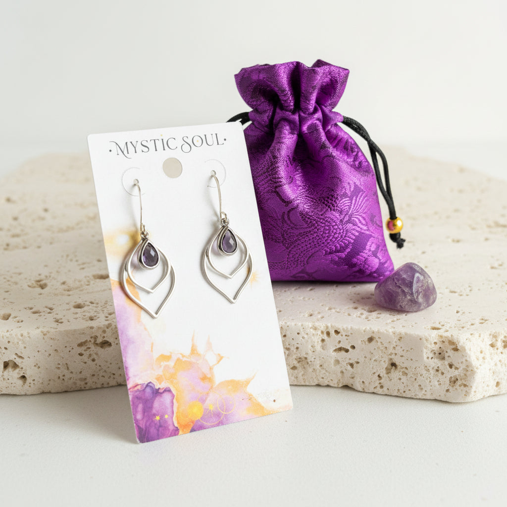 Amethyst purple faceted glass teardrop earrings in silver on a Mystic Soul Jewelry card with gift bag