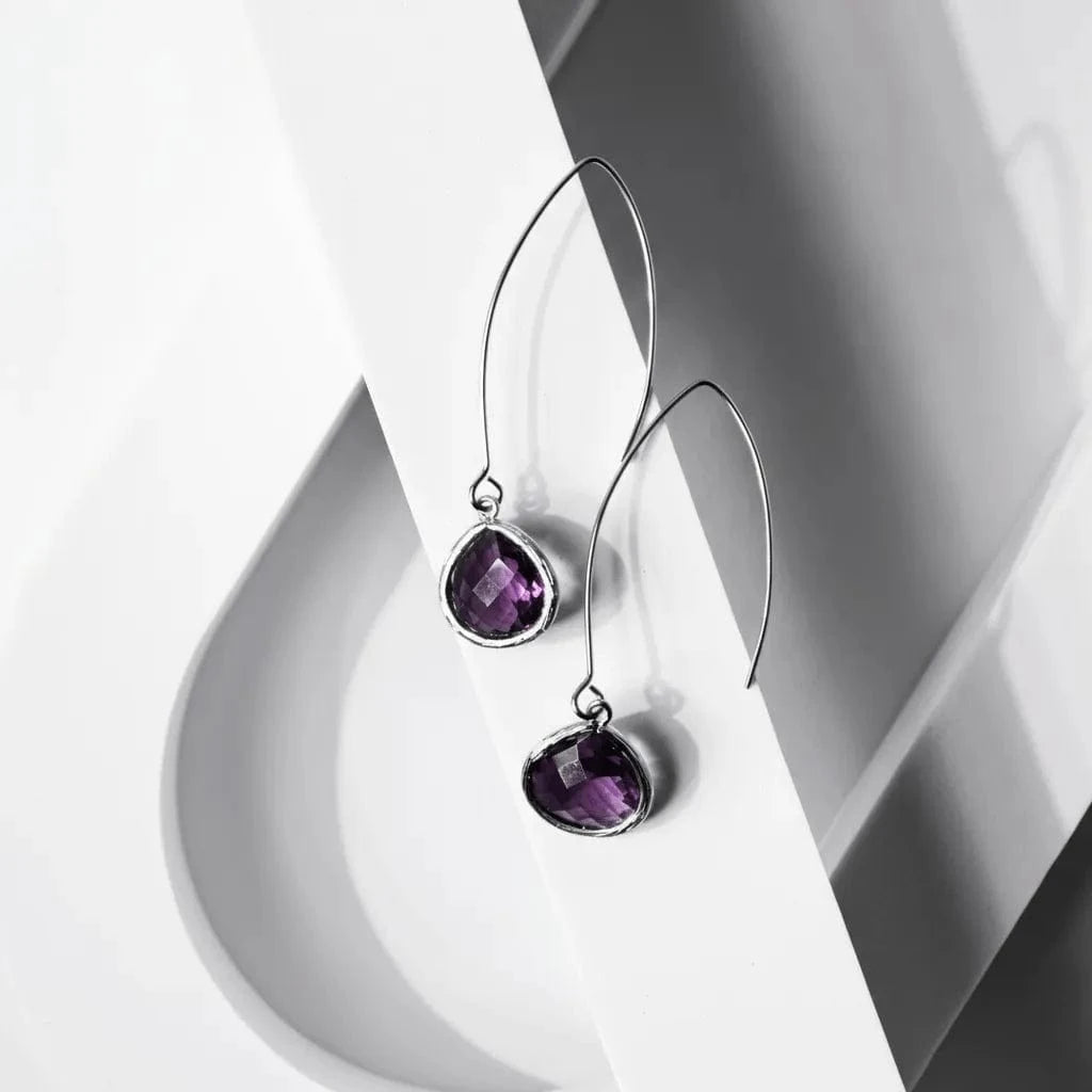 Purple gemstone earrings on a white background