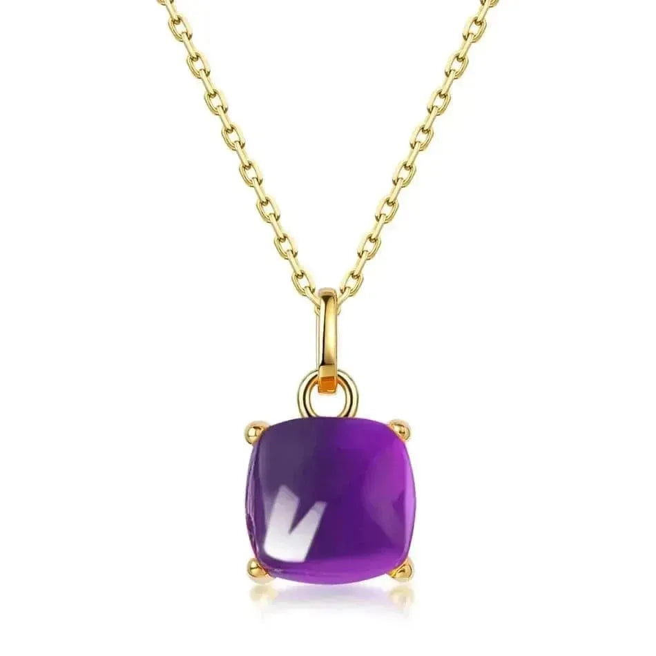 Gold necklace with a purple gemstone pendant on a white background