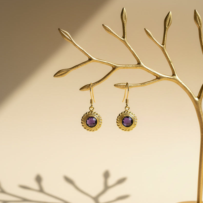 Close-up of an Amethyst Halo earring, purple hydro quartz ringed in etched gold