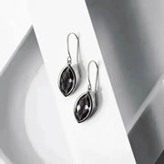 Pair of black teardrop earrings on a white background
