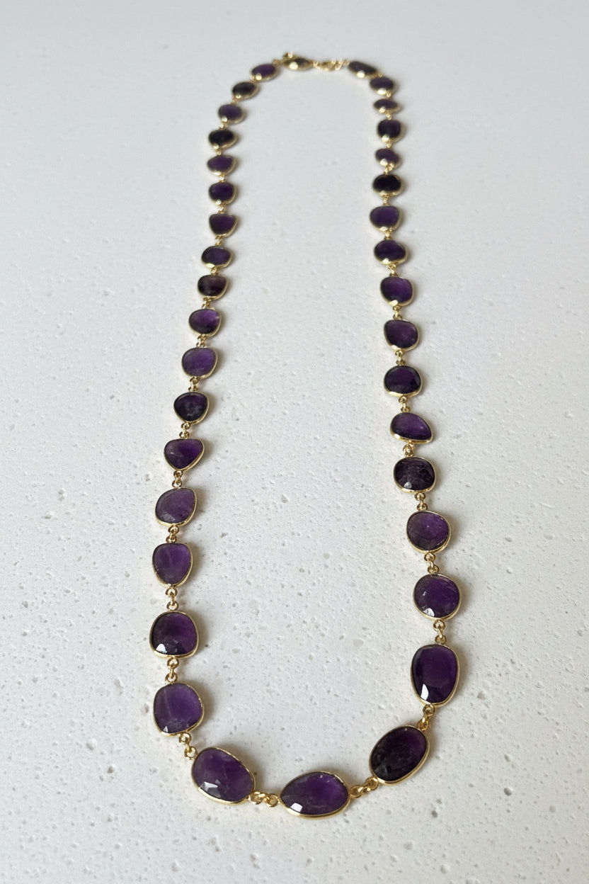 Full view of natural amethyst oval bracelet with 2 inch extension chain on gold plated links, February birthstone