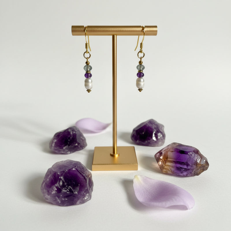 Close-up of amethyst, freshwater potato pearl and faceted labradorite drop earring