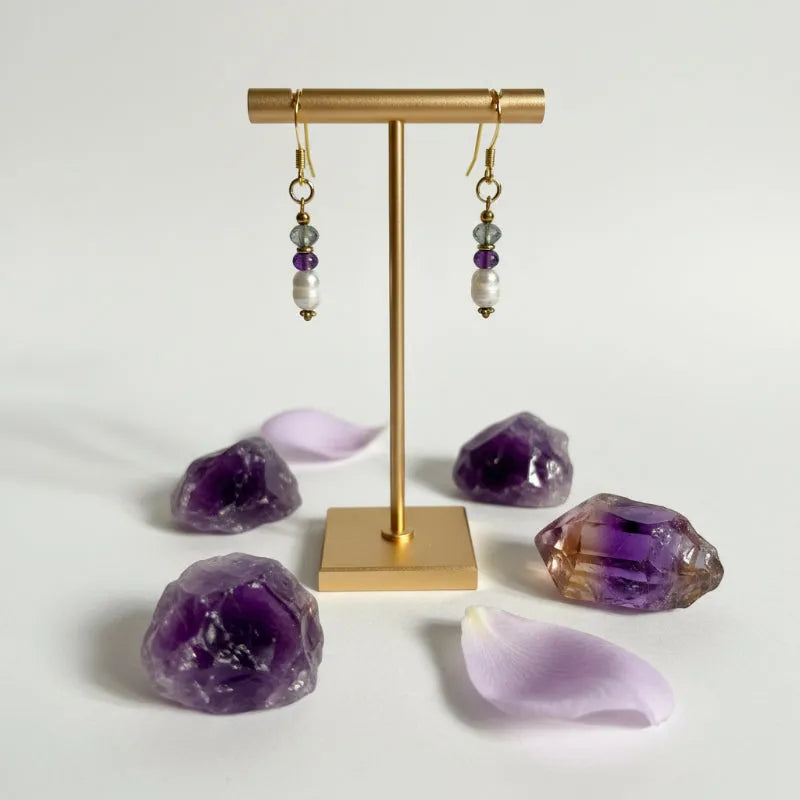 Close-up of amethyst, freshwater potato pearl and faceted labradorite drop earring