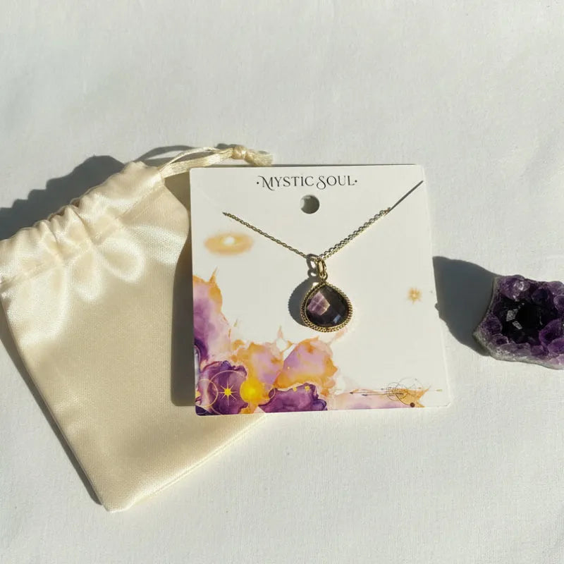 Ametrine pendant necklace on a gift card with its bag, purple and gold stone