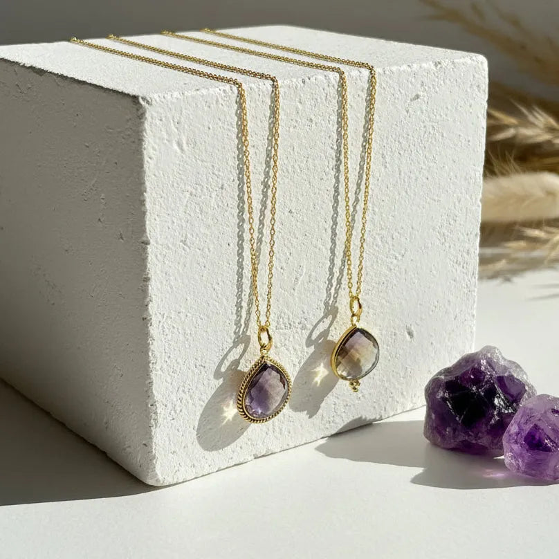 Ametrine pendant necklaces in dot and detailed edge designs side by side, purple and gold stone