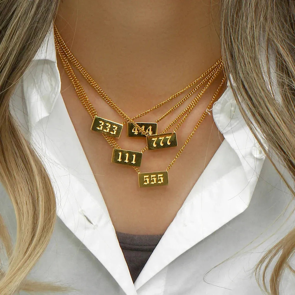 woman wearing Gold 111 333 444 555 777  angel number rectangle pendant necklaces  