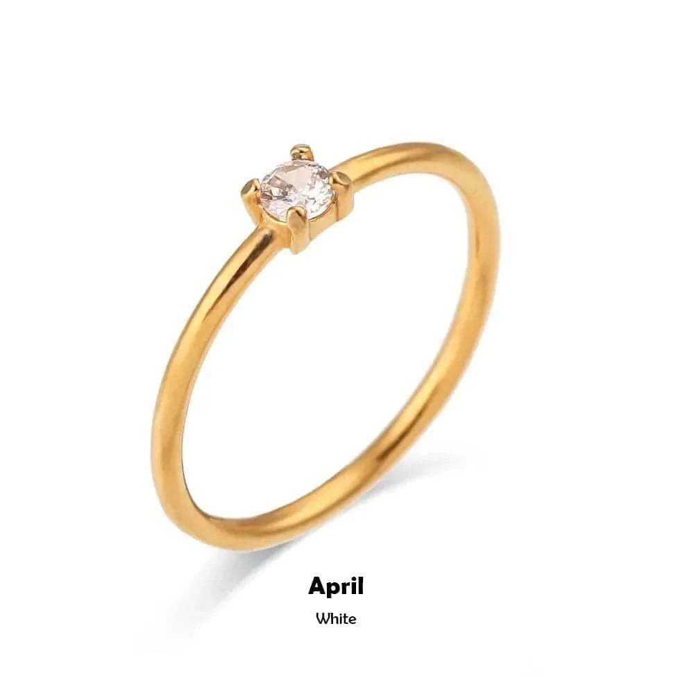 Gold ring with a small gemstone on a white background